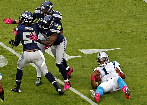 &lt;p&gt;Seattle's Bruce Irvin (51), Chris Clemons (91) and Jason Jones (90) celebrate a sack of Carolina's Cam Newton (1) during the second quarter Sunday in Charlotte, N.C.&lt;/p&gt;