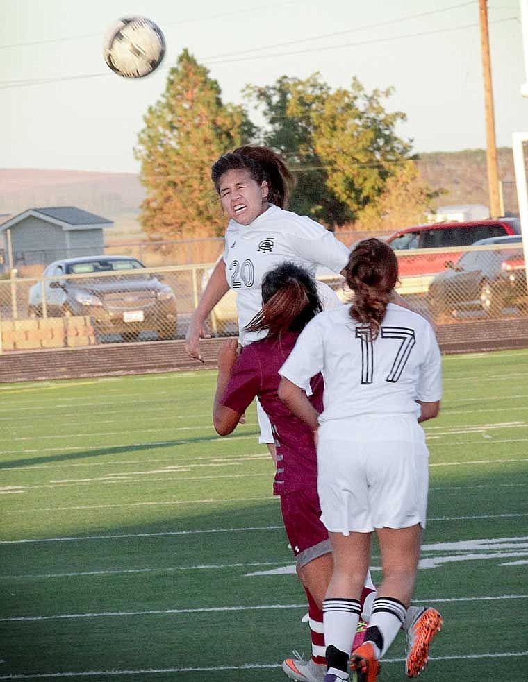 Cynthia Rodriquez closes her eyes but executes a header anyway in a match with Wahluke early last week.