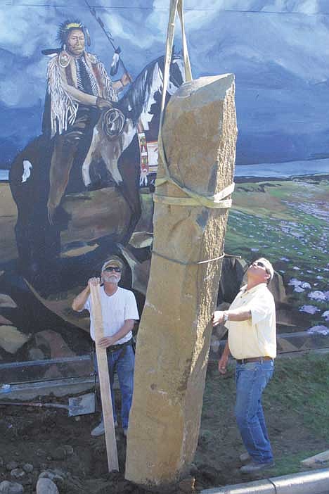 Erin Stuber/Columbia Basin Herald<br>North Central Construction workers Juan Moncada, far left, and Alan Horn support the basalt columns which were installed Thursday afternoon at the Chief Moses mural at Sinkiuse Square. The columns, weighing approximately 10,000 pounds each, were donated by Pamp and Barbara Maiers, owners of North Central Construction, who also donated the labor to install them. Also pictured (left to right) are Darrell Appleby, behind Horn, mural artist Patty Jensen, Colleen Trefz and Daniel Atnip.<br>Chief Moses keeps watch as Alan Horn and Darrell Appleby of North Central Construction oversee the installation of one of three basalt columns at the Chief Moses mural Thursday in Moses Lake. A celebration of the project's completion will be held Saturday, Oct. 16 at Sinkiuse Square.<br>Artist Patty Jensen and Colleen Trefz watch with delight as some of the final pieces of the Chief Moses mural  large basalt columns which make the painting a 3-D spectacle honoring the town's namesake  are placed by North Central Construction workers Thursday.