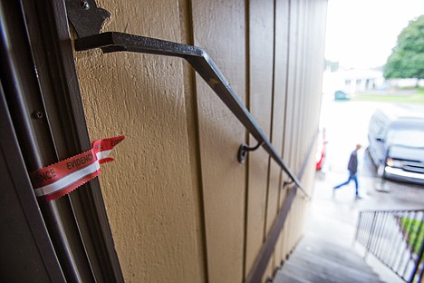 &lt;p&gt;Evidence tape sticks to the door jamb of the apartment where a Post Falls woman was found deceased on Monday.&lt;/p&gt;