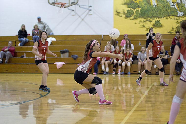 &lt;p&gt;A Lady Red Devil player returns the ball to St. Regis during one of their head-to-head matches.&lt;/p&gt;