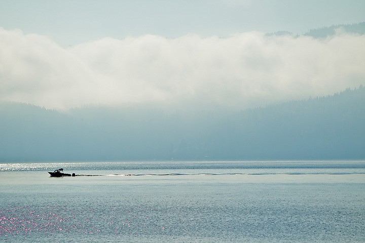 &lt;p&gt;JEROME A. POLLOS/Press A boat cruises across Lake Coeur d'Alene as the early morning fog settles across the hillsides lining the shoreline.&lt;/p&gt;