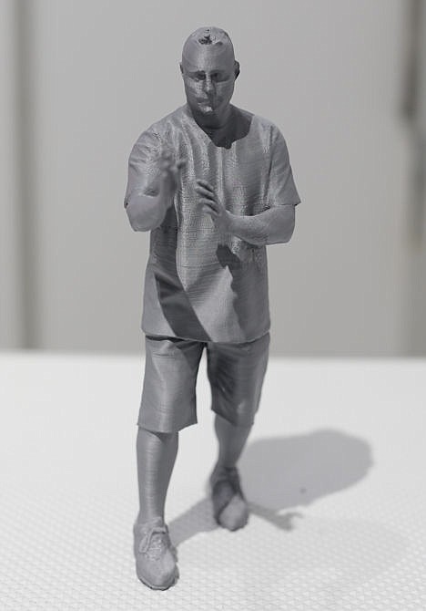 <p>A finished plastic statue, made with a 3-D scanner and printer, on display at Cubo toy store in New York, Aug. 14.</p>