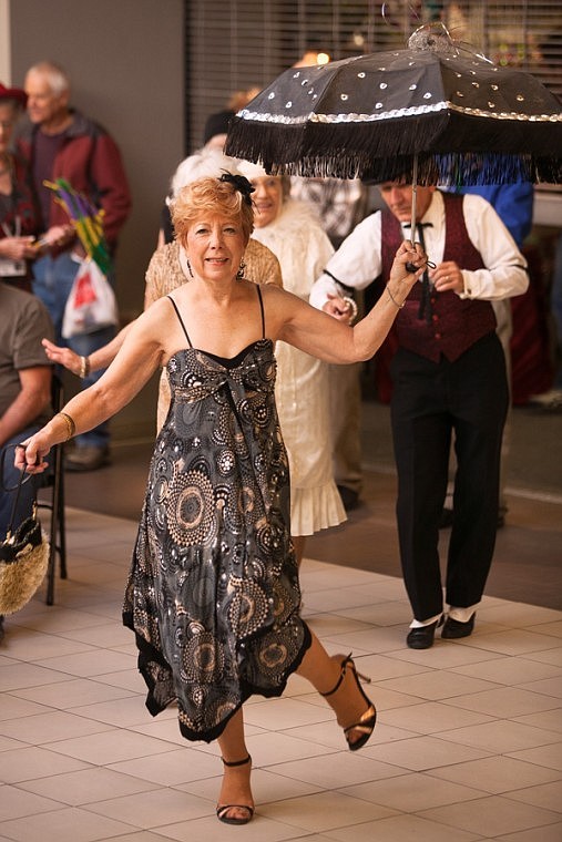 <p>Carol Beddes dances during the opening ceremony of the Glacier Jazz Stampede at the Kalispell Center Mall on Friday afternoon.</p>