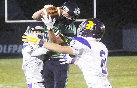 &lt;p&gt;Glacier's Noah Lindsay (17) catches the ball between Sentinel defenders Jackson King (3) and Colton Jacobson (2) during the first quarter. (Aaric Bryan/Daily Inter Lake)&lt;/p&gt;