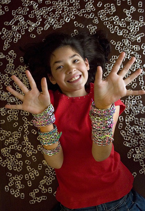 &lt;p&gt;This Oct. 1 photo shows Parker Salinas, 10, wearing can tab bracelets that she makes and sells to help raise money for breast cancer research in Roswell, Ga.&lt;/p&gt;