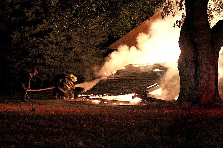 <p>Superior Volunteer Firefighters work to contain a fire that erupted late Sunday night. The fir started in an empty woodshed.</p>