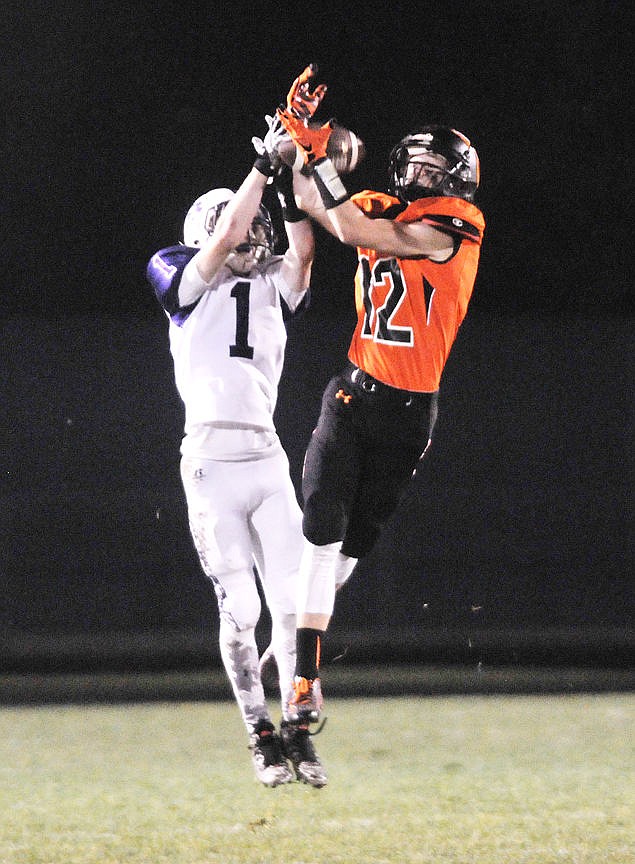 <p>Flathead's Tucker Cronk jumps in front of Butte's Kiley Caprara for an interception during the second quarter on Friday. (Aaric Bryan/Daily Inter Lake)</p>