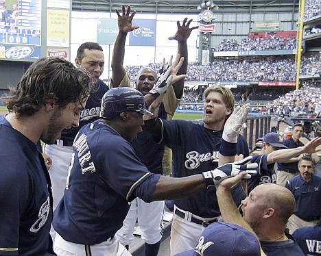 &lt;p&gt;Milwaukee&Otilde;s Yuniesky Betancourt is congratulated in the dugout after hitting a two-run home run during the fifth inning of Game 1 of the NLCS against St. Louis on Sunday in Milwaukee.&lt;/p&gt;