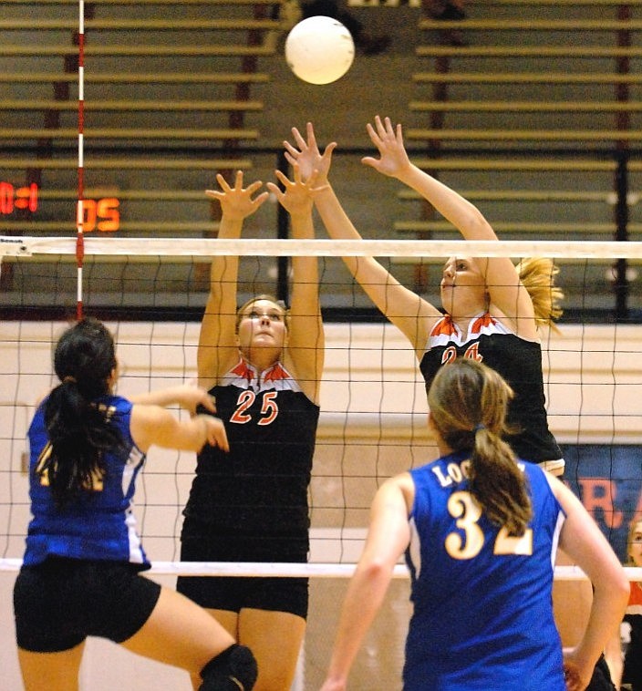 Flathead&#146;s Anika Thorderson (25) and Danika Johnson block a shot by Libby outside hitter Logan Best during the second game Thursday night at Flathead High School.