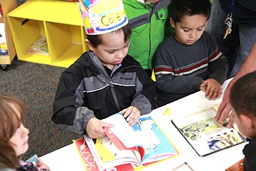 &lt;p&gt;Whitworth pores over the pages of a Dr. Seuss book.&lt;/p&gt;