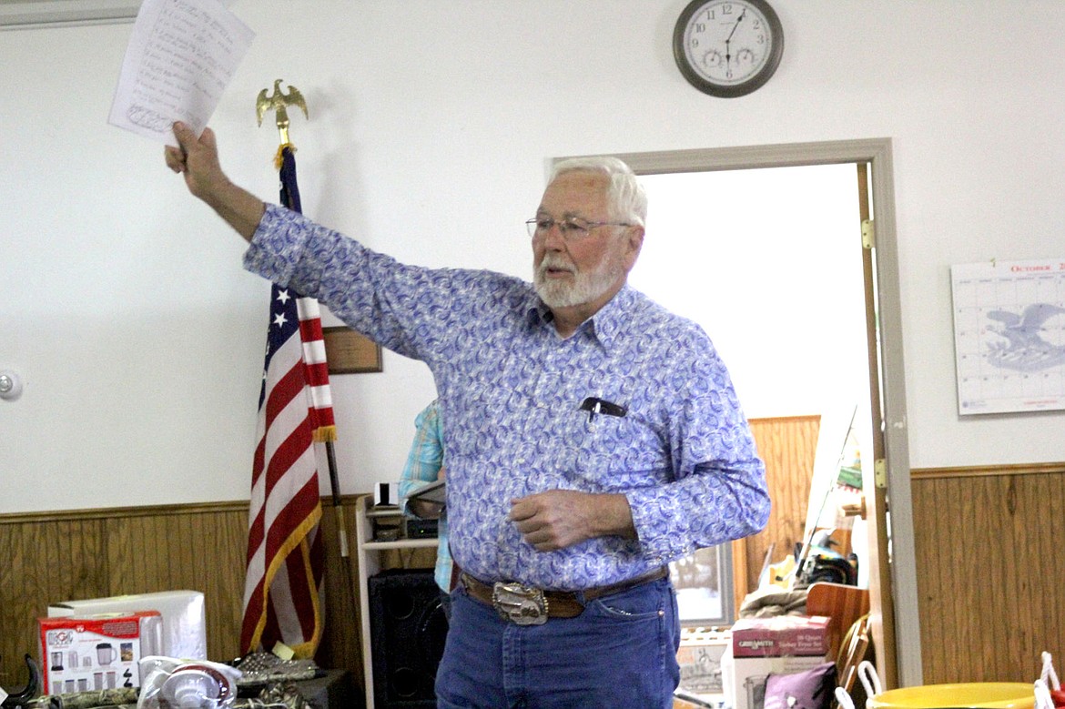 &lt;p&gt;Jim Ellis describes one of the items he will auction off at the St. Regis Community Center during a benefit auction for a Tricon employee whose home was destroyed in a fire.&lt;/p&gt;