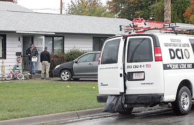 &lt;p&gt;Crime scene investigators at the residence of Sheena Devine, 404 W. Third, Apt. B Friday afternoon. (Paul Sievers/TWN)&lt;/p&gt;