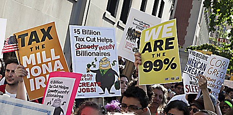 &lt;p&gt;Protestors affiliated with the &quot;Occupy Wall Street&quot; protests wave signs and banners outside 1185 Park Avenue, where Jamie Dimon, CEO of JP Morgan Chase, lives, during a march in New York, on Tuesday, Oct. 11, 2011. The crowd marched through out the Upper East Side neighborhood, protesting outside the homes of various billionaires and bank owners. (AP Photo/Andrew Burton)&lt;/p&gt;