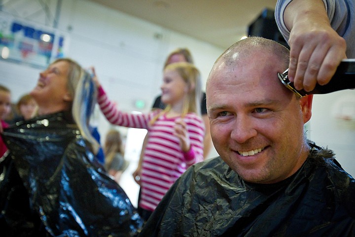 &lt;p&gt;Corey Still, a fourth grade teacher at Mullan Trail Elementary, grins at the crowd as his head is buzzed with a set of clippers and his principal has her hair spray dyed by student Laney Smith during an assembly.&lt;/p&gt;