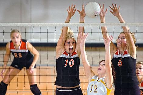 Flathead High School&#146;s Shaina Evans (10) and Britta Thorderson go up for a block while Libby&#146;s Shelby Barton sets the ball during Thursday&#146;s volleyball match at Flathead High School. Flathead edged Libby 3-2.Garrett Cheen/Daily Inter Lake