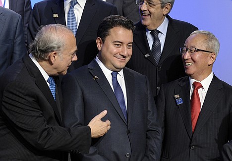 &lt;p&gt;Organization for Economic Co-operation and Development (OECD) Secretary-General Angel Gurr&#146;a, left, Turkish Deputy Prime Minister Ali Babacan, center, and South Korean Finance Minister Ali Babacan right, talk before posing for a photo with the Group of 20, Friday, Oct. 11, 2013, at the International Monetary Fund (IMF) headquarters in Washington.&lt;/p&gt;