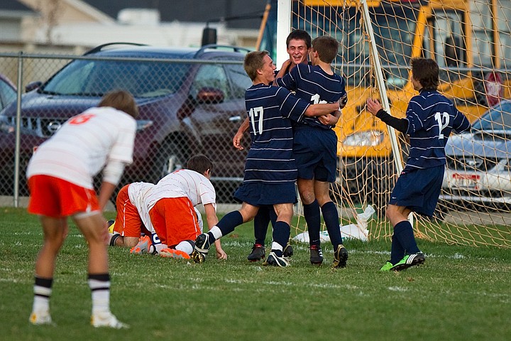 &lt;p&gt;Lake City boys soccer players celebrate following an overtime goal scored by Donald Osborne-Moss Tuesday against the Trojans in Post Falls. The win guarantees the Timberwolves a berth in the state championship tournament.&lt;/p&gt;