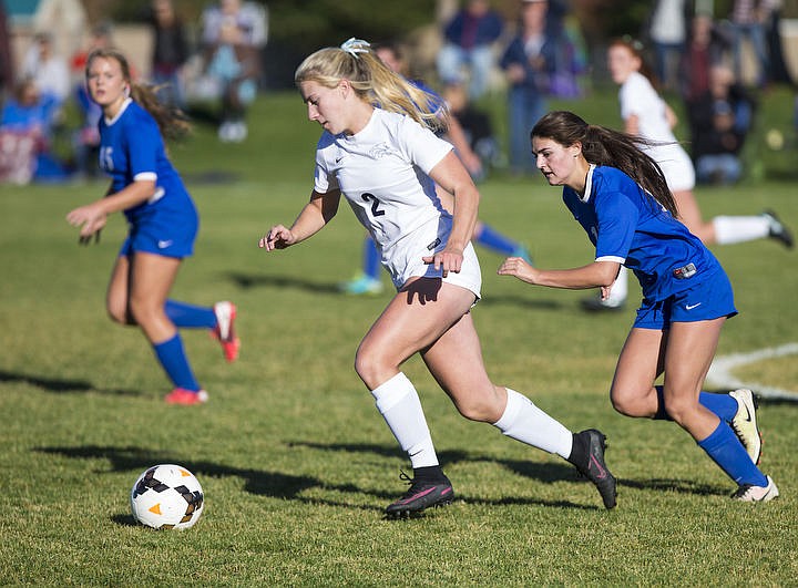 &lt;p&gt;LOREN BENOIT/Press Lake City's Annica Wilson, center, heads downfield with the soccer ball during Tuesday's 5A Region 1 championship match against Coeur d'Alene at Lake City High School.&lt;/p&gt;