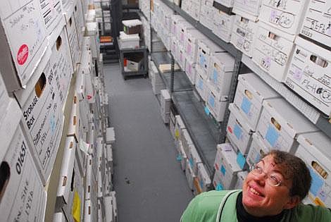 Flathead County Records Manager Jan Hardesty looks up at dozens of county records boxes Thursday at the Flathead County Records Department. Garrett Cheen/Daily Inter Lake