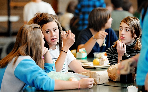 Erin Hibbs, left to right, Rebecca Konen, and Megan Bridwell, eighth graders at Kalispell Middle School chat as the lunch crowds begins to pack up on Tuesday in Kalispell.