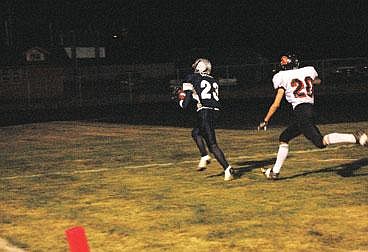 &#151;Photo by ROBERT JAMES&lt;br&gt;Daniel Botkin (23) sprints into the end zone ahead of Priest River's J.P. Ramsey to score the Badgers' first touchdown in their 12-7 win.