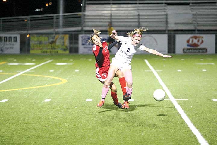 Senior forward Caylah Lunning (8) collides with a Grizzly defender.