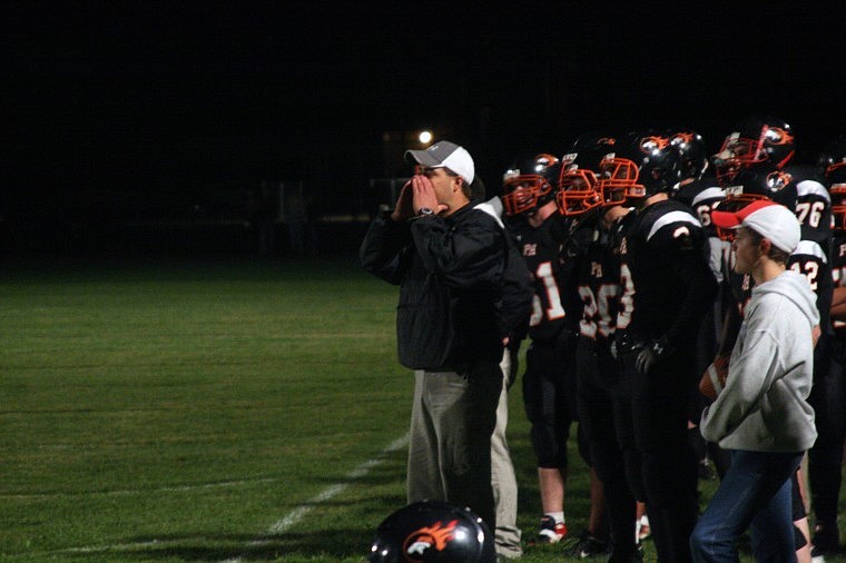 Plains-Hot Springs head coach Jim Lawson calls in a play from the sideline.