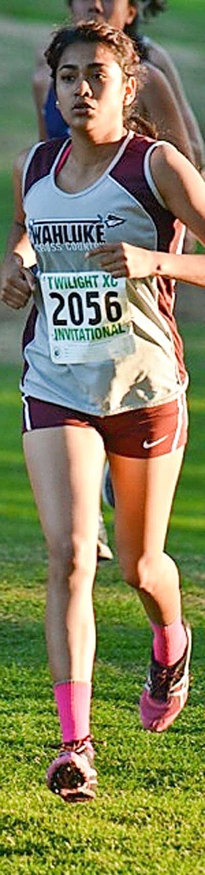 Senior Guadalupe Abarca runs fourth for the Wahluke girls and Angel Valdenea runs third for the boys.