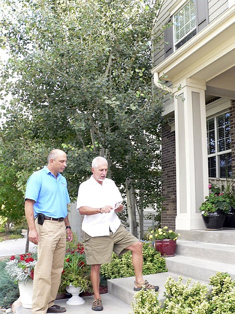 &lt;p&gt;This Monday, Oct. 4, 2010 photo released by Jennifer Forker shows Jon Elliott of Swingle Lawn, Tree &amp; Landscape Care, left, as he talks with Kemper Smith about the aspen trees growing too close to his Golden, Colo., home. &quot;I never thought they'd get that big,&quot; Smith said. The trees are healthy, so they'll keep growing -- up to three times taller, Elliott said. He suggested that Smith prune the trees.&lt;/p&gt;