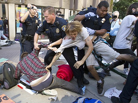 &lt;p&gt;San Diego police officers haul off Occupy San Diego protesters as they remove tents and structures from the Civic Center Plaza Friday in San Diego. One man was arrested Friday as police officials removed the tents, where protesters have been camping out for days.&lt;/p&gt;