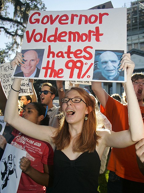 &lt;p&gt;Brandi Braschler holds up her sign critical of Florida Gov. Rick Scott at the Occupy Tallahassee demonstration Friday.&lt;/p&gt;