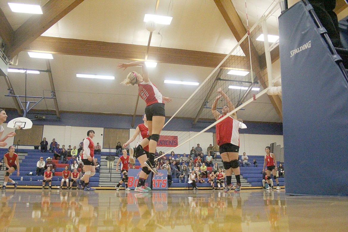 <p>Jordan Mueller goes up high for the Lady Bobcats against Two Eagle River last week during homecoming in Superior.</p>