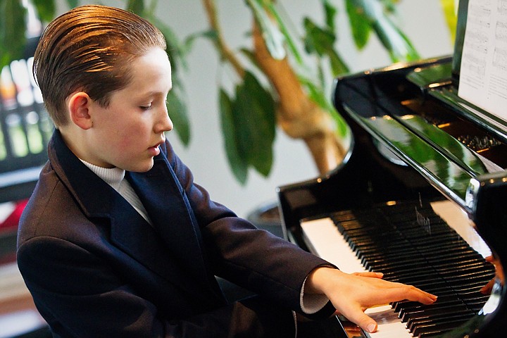 &lt;p&gt;Val Wold, 11, plays crosses his hands the reach the higher keys on his piano Monday while playing a song in the rotunda of his home near the Spokane River.&lt;/p&gt;