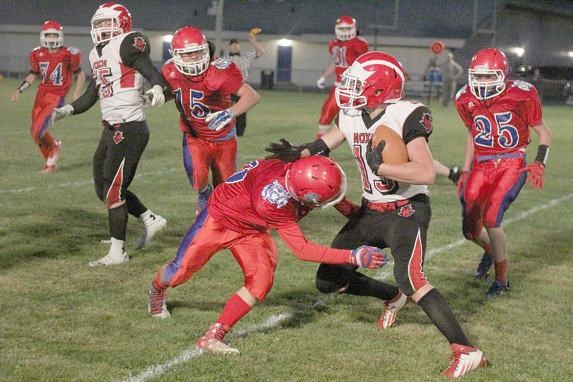 <p>Senior running back Luke Crowe of the Noxon Red Devils shakes off a tackler during last Friday night's game in Superior.</p>