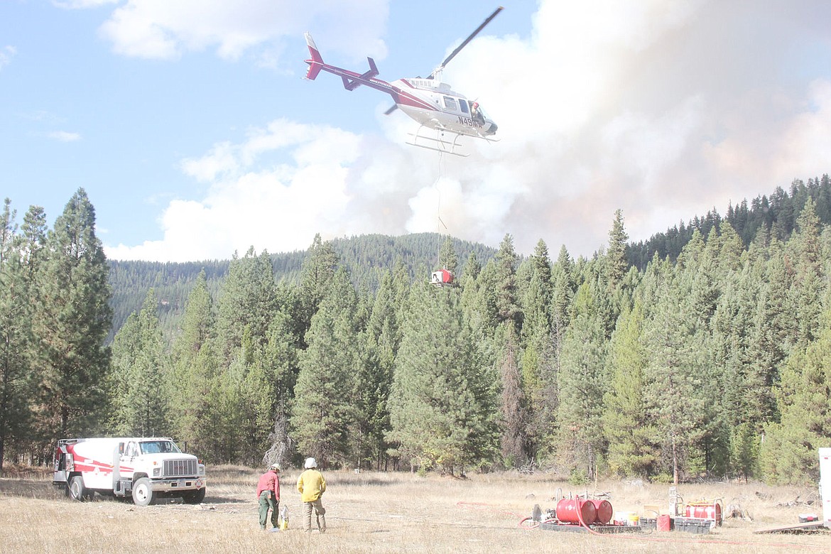 &lt;p&gt;Forest Service personnel watch as a helicopter equipped with a heli-torch takes off for the CC Divide prescribed burn seen in the background.&lt;/p&gt;