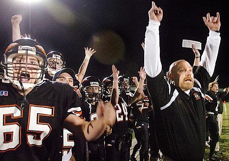 Flathead football players and coaches celebrate after Brock Osweiler's 47-yard Hail Mary pass to end the first half Friday night in Kalispell. The touchdown put the Braves up 29-0. The Braves allowed Butte back into the game, but held on for a 35-20 victory. Chris Jordan/Daily Inter Lake