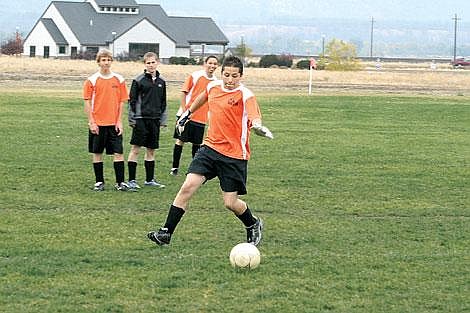 Jennifer McBride/Valley Press Junior Dillon Fryxell runs through a horde of Thompson Falls players who eventually bring him down.