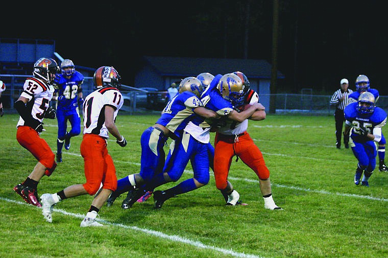 &lt;p&gt;A group of Thompson Falls Bluehawks swarm the ball during Friday night's game against Ronan.&lt;/p&gt;