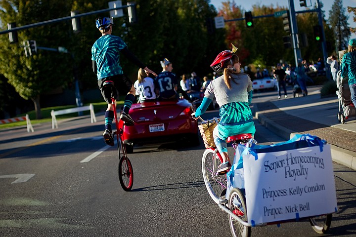 &lt;p&gt;JEROME A. POLLOS/Press Lake City High senior class princess Kelly Condon looks toward the spectators as she pedals along Sherman Avenue on her tricycle and prince Nick Bell maintains his balance on a unicycle Friday during the Lake City High homecoming parade.&lt;/p&gt;