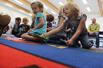 &lt;p&gt;Mercy, 3, arranges some dinosaur pictures while substitute Little Cherries instructor Desiree Alexander directs other kids.&lt;/p&gt;