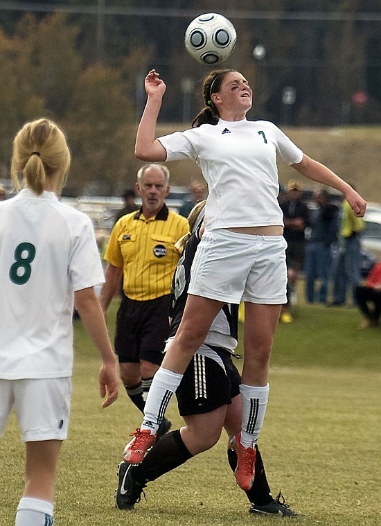 Whitefish High School freshmen midfielder Megan Danczyk heads the ball over Frenchtown player Courtney Richards during the Class A playoff game in Whitefish Saturday.