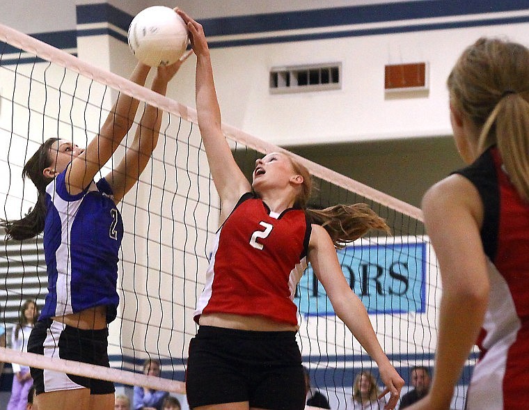 Stillwater Christian School&#146;s Julia Bray (left) goes up to block a tip at the net by Hot Springs&#146; MacKenzie Wood  as Hot Springs&#146; Devon White looks on in the second set of Tuesday evening&#146;s game at Stillwater.