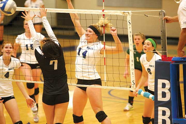 Freshman outside hitter Shania Bateman (14) spikes the ball over the net against freshman setter Rachel Asano (7) during Big Bend Community College's win Wednesday night. Bateman finished the match with 20 kills and four digs.