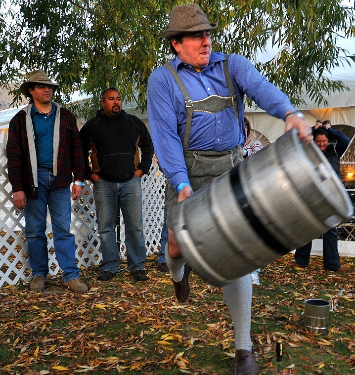 Donnie Clapp demonstrates how to throw a keg for competitors in the Keg Hurling Contest Thursday evening at the Great Northwest Oktoberfest in Whitefish. The event continues through Sunday at Depot Park.