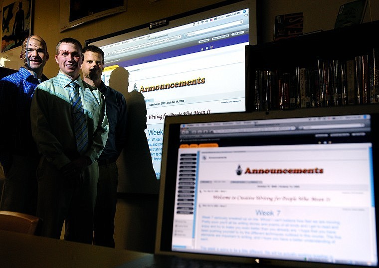 From left, Bigfork High School librarian and activities director Matt Porrovecchio, Principal Matt Jensen, and English and journalism teacher Charlie Appleby pose in front of a projector screen displaying the Virtual High School program&#146;s home page.