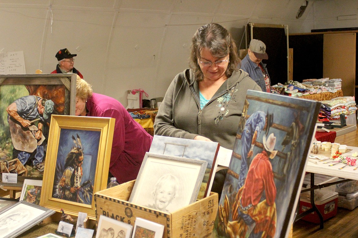 <p>Sue Hummel prepares her receipt book for a sale during the MC Help line’s Fall Bazaar at the Superior 4H building.</p><div><strong> </strong></div>