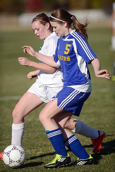<p>Whitefish freshman Anna Peterson (9) and Libby sophomore Kasie Berget (5) battle for possession of the ball during the first half of their playoff game on Tuesday afternoon in Whitefish. Whitefish won the match up 8-0.</p>