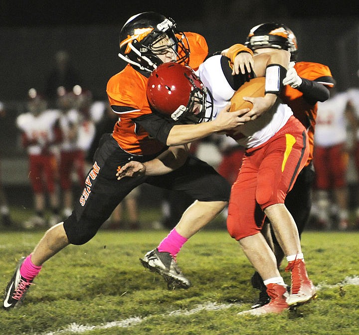 &lt;p&gt;Flathead's Gauge Triplett, left, and Jacob Ridgeway sack Missoula Hellgate's quarterback Dylan Botsford during the first quarter at Legend's Stadium on Friday. (Aaric Bryan/Daily Inter Lake)&lt;/p&gt;