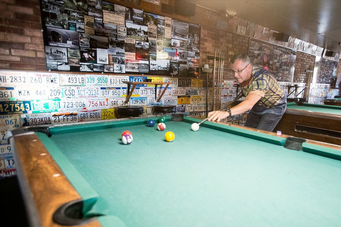 &lt;p&gt;Rex Atkinson of Post Falls lines up his pool shot on Friday at Bob's 21 Club in Post Falls. Adorning the walls behind Atkinson are license plates from every state as well as historical photos from Kootenai County and the surrounding areas.&lt;/p&gt;